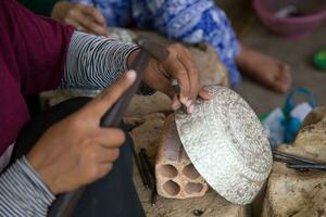 Artisan chiseling a bowl photo