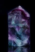 Macro mineral stone Fluorite crystal on a black background photo