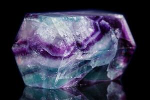 Macro mineral stone Fluorite crystal on a black background photo