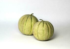 Two tasty fresh honey ripe melons isolated on white. photo