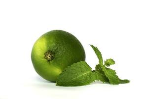 Fresh lime with mint leaves on white background photo