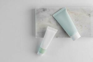 Cosmetic bottles onmarble stone podium on the background. Background for cosmetic product branding, identity and packaging, top view photo