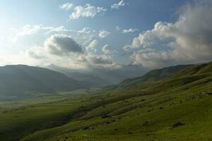 Low clouds above green valley in the mountain photo