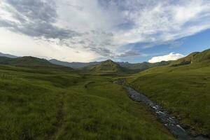 Green valley and mountain stream in Drakensberg photo