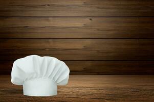 Wooden table with empty space and chef's hat photo