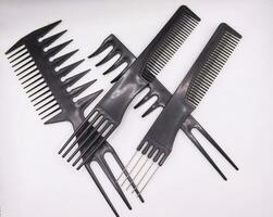 set of combs, hairstyle accessories,Black comb isolated on white background.Trendy design haircare icons set. Metal and plastic comb, cylinder and brush professional black hair styling accessories too photo