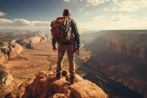 Adventurous Man Standing on the Top of a Cliff at Bright Day photo