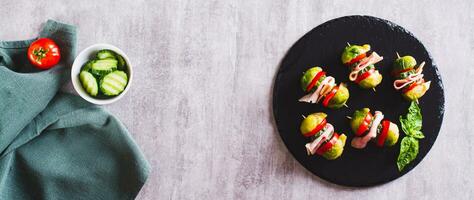 Appetizing sliders with vegetables and ham on a slate board top view web banner photo