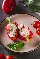 Stuffed peppers with fresh vegetable salad with yogurt on a plate vertical view photo