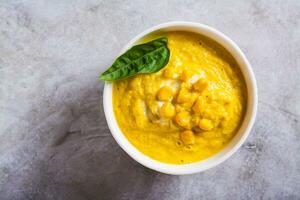 Close up of delicious corn cream soup in a bowl on the table top view photo
