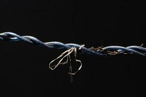 Laos drying clothes with wires tangled around and tied with ropes, creating a strange picture in dark tones. photo