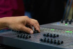 elderly man's hand who is controlling the mixer sound system check At the concert, stage, performers with confidence photo