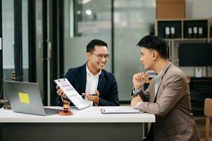 business people and lawyers discussing contract papers sitting at the table. Concepts of law, advice, legal services. photo