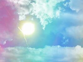 beauty sweet pastel yellow sun blue green colorful with fluffy clouds on sky. multi color rainbow image. abstract fantasy growing light photo