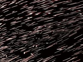 abstract golden star comet glowing shiny lights. bokeh firework lines gold color in black night. multi lines effect holiday bright. photo