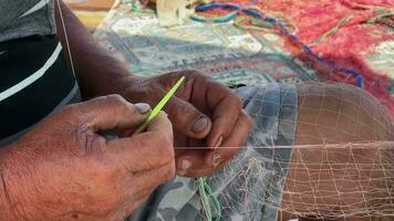 Fisherman is Repairing Fishnets video