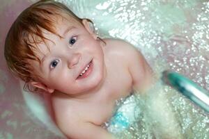 Little boy takes a bath. photo