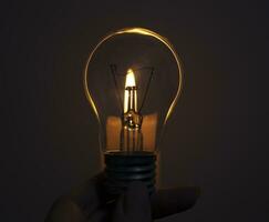 Candle on light bulb. Blackout, electricity off, energy crisis or power outage, concept image photo