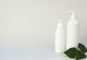 collection of various cosmetic hygiene containers on a gray background. Free space for text photo