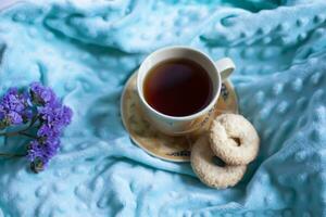 Cozy autumn composition with a large cup of coffee and cute decor details in the bed. photo