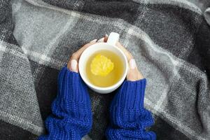 Female hands with a cup of herbal tea photo