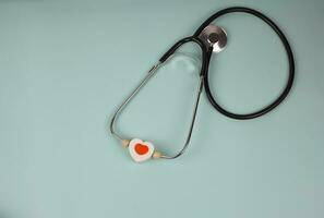 A file folder, a stathoscope and a heart on ekg. photo