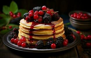 Stack of fresh fluffy pancakes decorated on top with forest berries rotating on a plate and pouring honey syrup. Delicious, healthy. Fresh bakery concept. photo