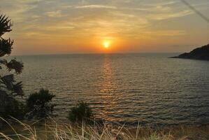 A yacht at sunset on the sea's surface. Sunset with A yacht's silhouette, Thailand photo