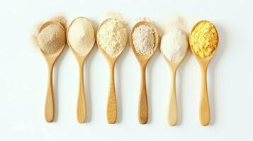 Wooden spoons of various gluten free flour almond flour, amaranth seeds flour, buckwheat flour, rice flour, chick peas flour from top view White background. photo