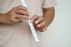 Hands of a musician playing the flute. Musical instrument. Concept, love music. Melody therapy, make concentration. Man practice to play music for being professional flutist photo