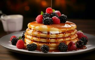 Stack of fresh fluffy pancakes decorated on top with forest berries rotating on a plate and pouring honey syrup. Delicious, healthy. Fresh bakery concept. photo