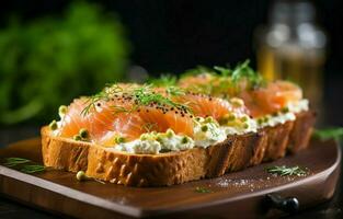Rye bread toast topped with cream cheese, avocado, and smoked salmon. Perfect for breakfast, lunch, appetizer or snack. photo