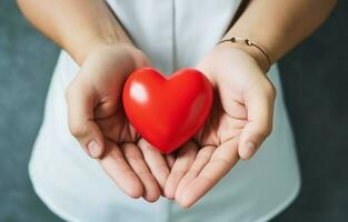 A man gives a red heart to a child as a couple in a hospital, symbolizing Valentine's Day. The image is taken from a top view with space for text. photo