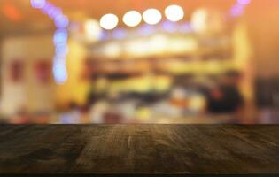 Empty dark wooden table in front of abstract blurred bokeh background of restaurant . can be used for display or montage your products.Mock up for space. photo