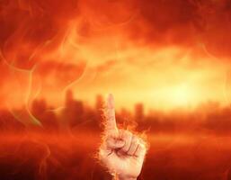 hand man with blur city and fire background. hot tone. global warming, el nino and net zero concept. photo