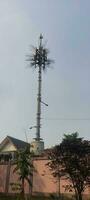 a cell phone tower in front of a building photo