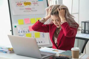 Concept Burnout Syndrome. Asian business Woman feels uncomfortable working. Which is caused by stress, accumulated from unsuccessful work And less resting body. Consult a specialist psychiatrist. photo