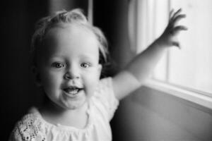 Portrait of happy one year old girl in black and white photo