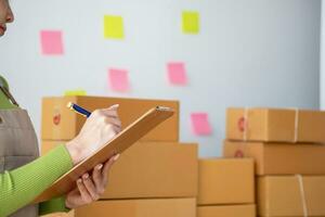 Starting a small business SME business owners, entrepreneurs, unboxing work check order online To prepare to pack into boxes for sale to customers, SME business ideas online. photo