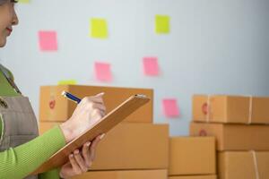 Starting a small business SME business owners, entrepreneurs, unboxing work check order online To prepare to pack into boxes for sale to customers, SME business ideas online. photo