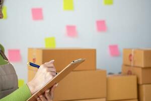 Starting a small business SME business owners, entrepreneurs, unboxing work check order online To prepare to pack into boxes for sale to customers, SME business ideas online. photo