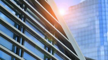 Modern office building in the city with windows and  steel and aluminum panels wall. Contemporary commercial architecture, vertical converging geometric lines. photo