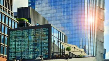 Glass modern building with blue sky background. View and architecture details. Urban abstract - windows of glass office building in  sunlight day. photo