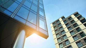 Modern office building with glass facade on a clear sky background. Transparent glass wall of office building. photo