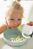 Child with milk, snack and cartoons on TV photo