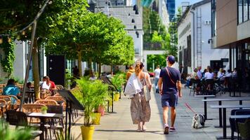 Portrait of a young couple walking their dog on a city street. photo