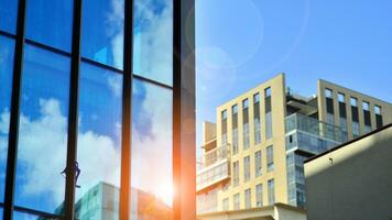 Structural glass wall reflecting blue sky. Abstract modern architecture fragment. Glass building with transparent facade of the building and blue sky. Contemporary architectural background. photo