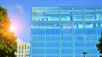 Fresh green trees and office building, business concept. Eco building in modern city concept. photo