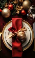 Christmas table setting with christmas gold and red dinnerware photo