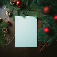 White paper on christmas background covered by fir branches with red photo